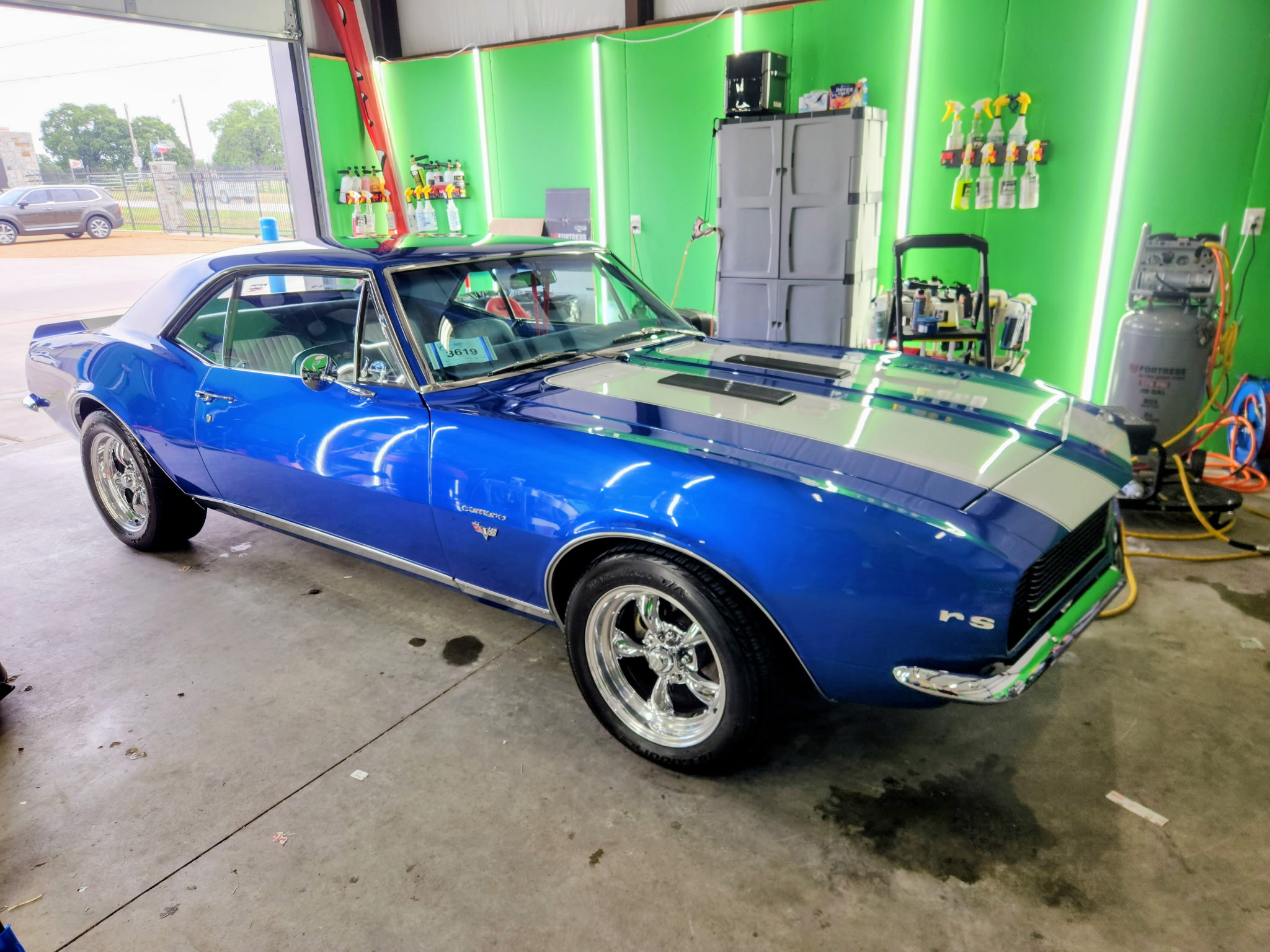 Professional car detailing service showing clean vehicle exterior with glossy finish
